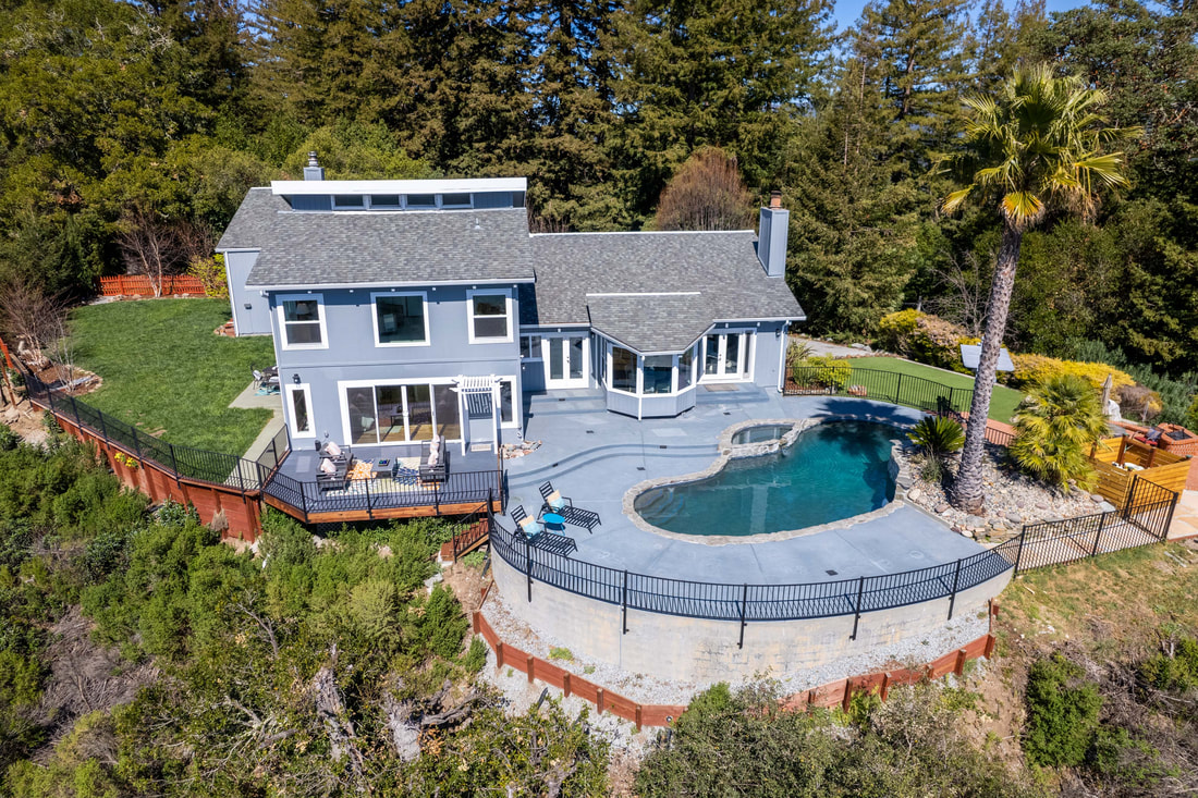 Drone photography of home with swimming pool.