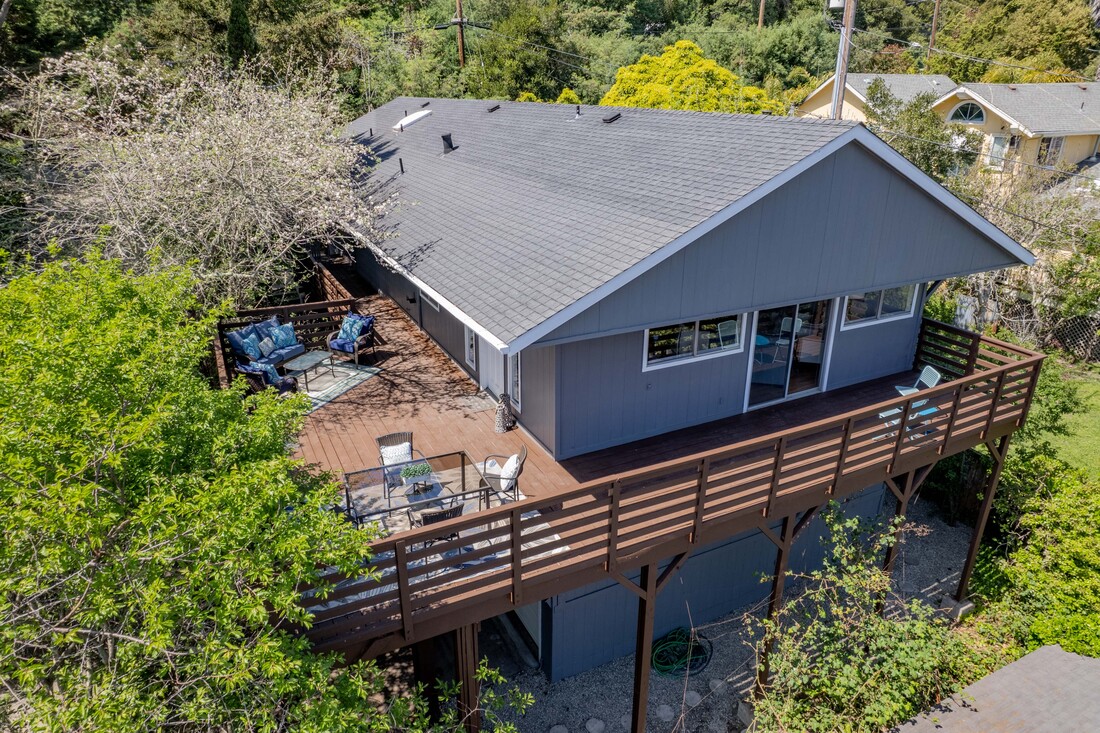 Drone photo of deck with cabin in the Santa Cruz Mountains by Sand and Stone Media.