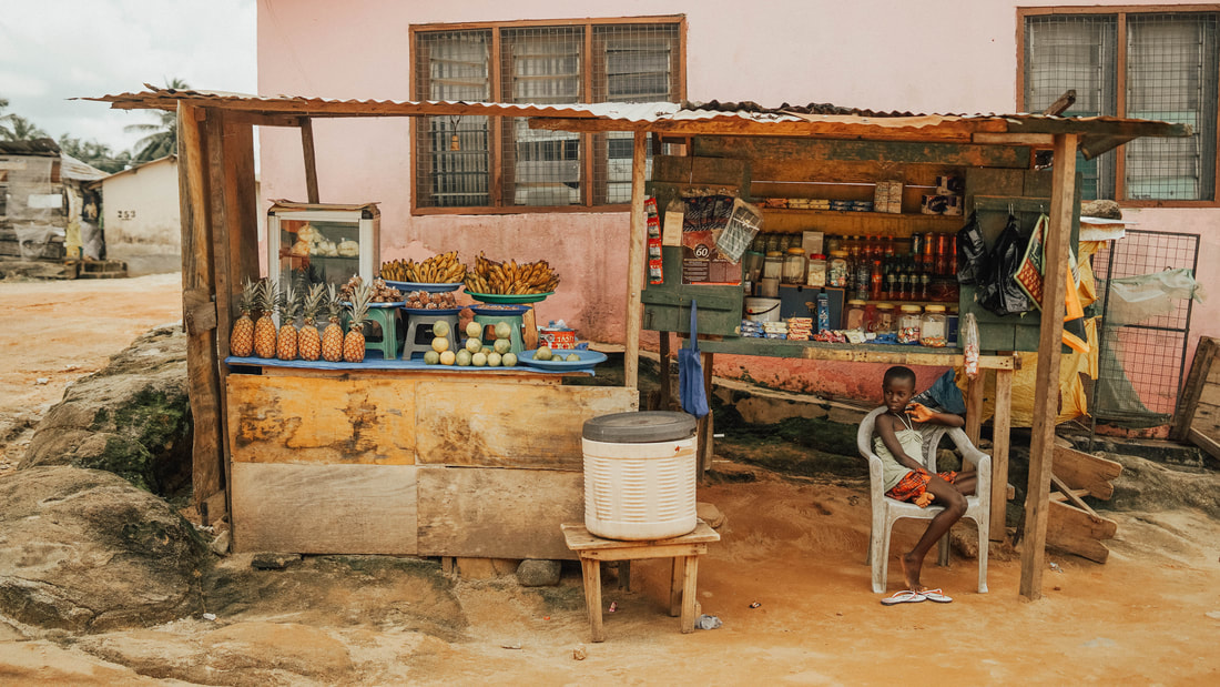 Kid selling food on the side of the road in Ghana Travel videography taken by Santa Cruz wedding and elopement photographer and videographer 