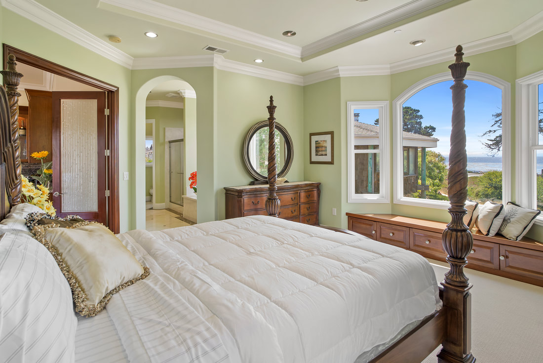 Luxury Real estate listing with ocean view from bedroom.