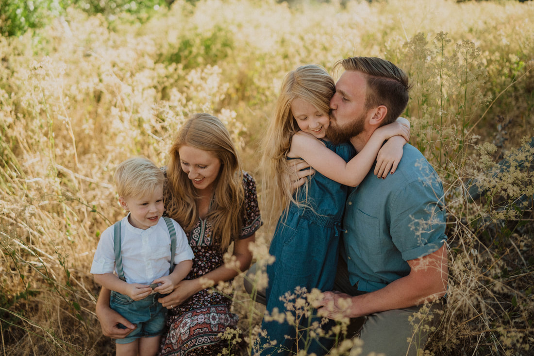 Family photo session in tall grass taken by Santa Cruz wedding and elopement photographer and videographer 