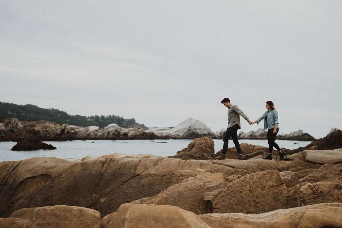 Couple holding hands in Big Sur during engagement session taken by Santa Cruz wedding and elopement photographer and videographer 